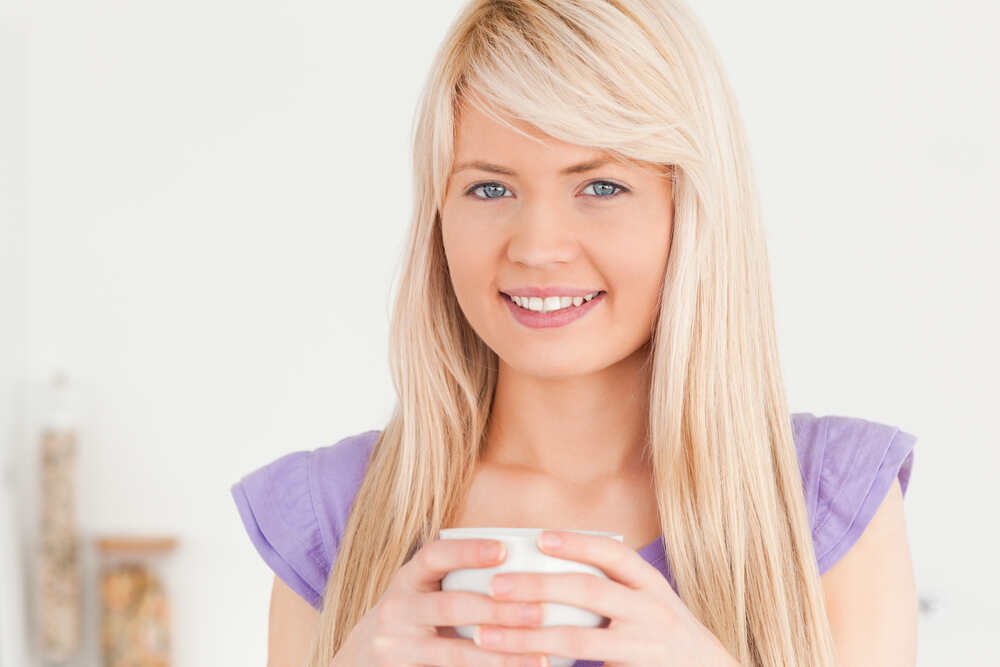 Blonde lady with natural smooth lips smiles.Medazur Medical Clinic in Leytonstone.