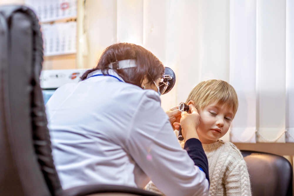 ENT doctor examines young boy's ear. Medazur Medical Clinic in Leytonstone.