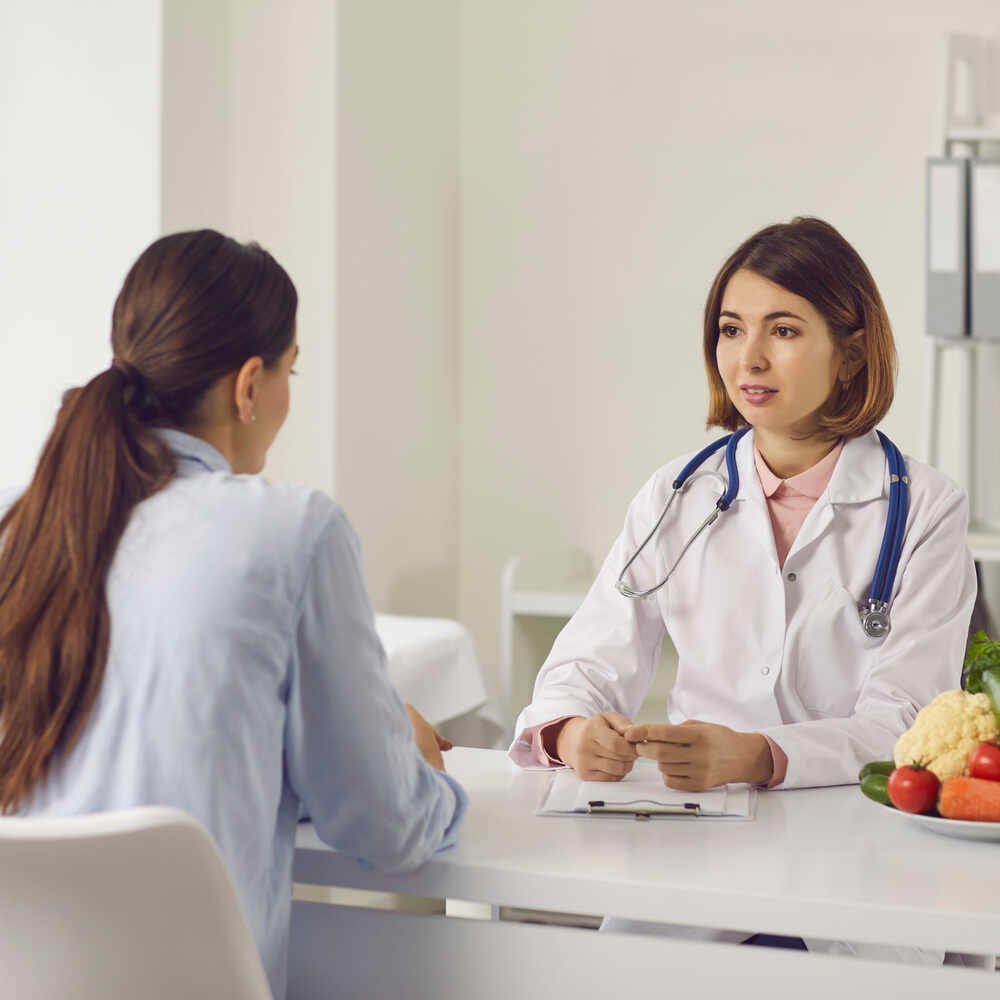 Female patient speaking to doctor. Medazur Medical Clinic in Leytonstone.