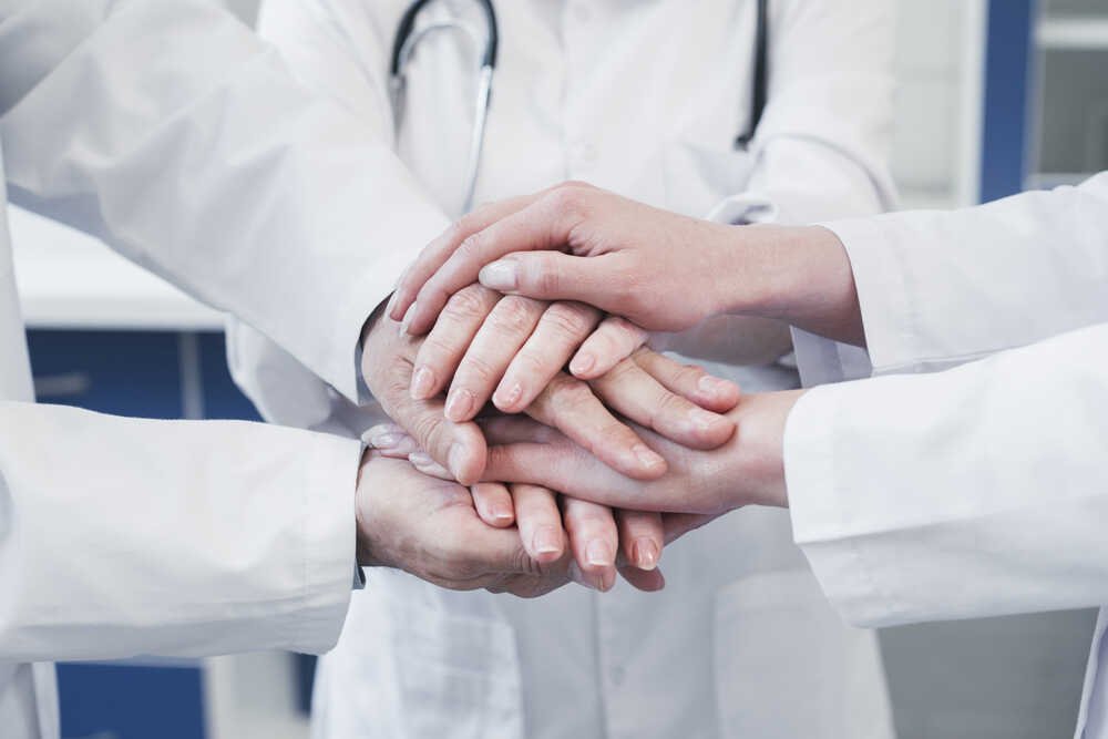 Doctors holding hands. Hands view only. Medazur Medical Clinic in Leytonstone.