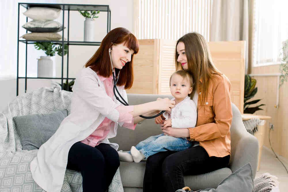 Lady paediatrician examines child. Medazur Medical Clinic in Leytonstone.
