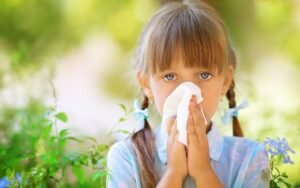 Home 18 Young girl with spring allergy blows her nose with tissue. Medazur Medical Clinic.